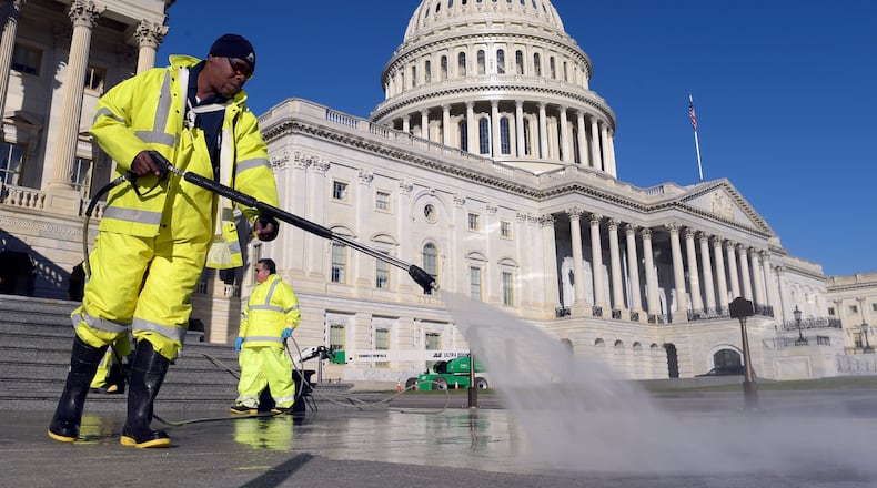 Carroll Rodgers of Suitland, Md., cleans the steps on Capitol Hill in Washington on Election Day. (AP Photo/Susan Walsh)