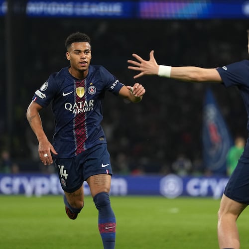 PSG's Desire Doue, left, celebrates with PSG's Khvicha Kvaratskhelia after scoring the opening goal during the Champions League quarterfinal first leg soccer match between Paris Saint-Germain and Liverpool in Paris, Wednesday, April 8, 2026. (AP Photo/Thibault Camus)