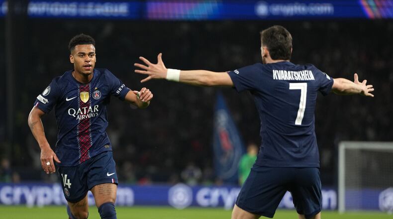 PSG's Desire Doue, left, celebrates with PSG's Khvicha Kvaratskhelia after scoring the opening goal during the Champions League quarterfinal first leg soccer match between Paris Saint-Germain and Liverpool in Paris, Wednesday, April 8, 2026. (AP Photo/Thibault Camus)