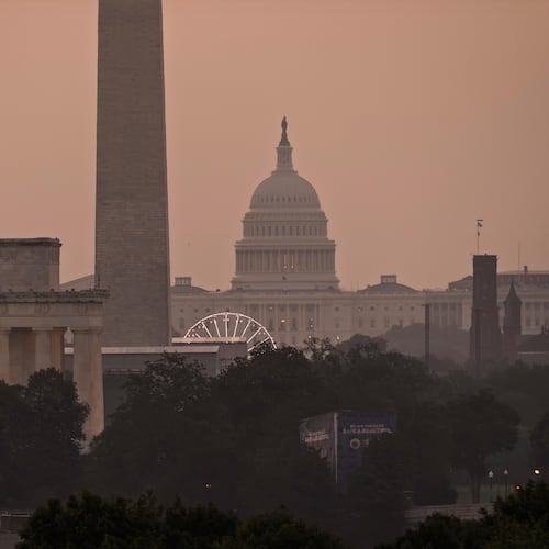 The Lincoln Memorial, the Washington Monument, and the U.S. Capitol, are seen at dawn from an overlook in Arlington, Va., as Washington prepares for sweltering temperatures, Friday, July 3, 2026. (AP Photo/J. Scott Applewhite)