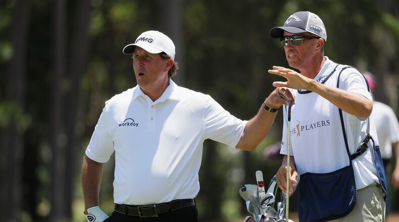 Phil Mickelson and his left-hand man, caddie Jim Mackay, plot a shot at this year's Players Championship.(Jamie Squire/Getty Images)