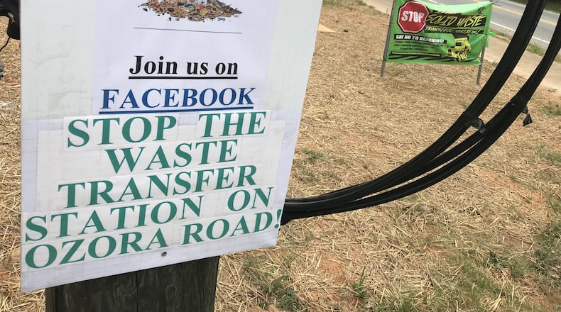 A pair of signs along Ozora Road in near Loganville in Gwinnett County, where neighbors are mounting opposition to a proposed solid waste transfer station. TYLER ESTEP / TYLER.ESTEP@AJC.COM