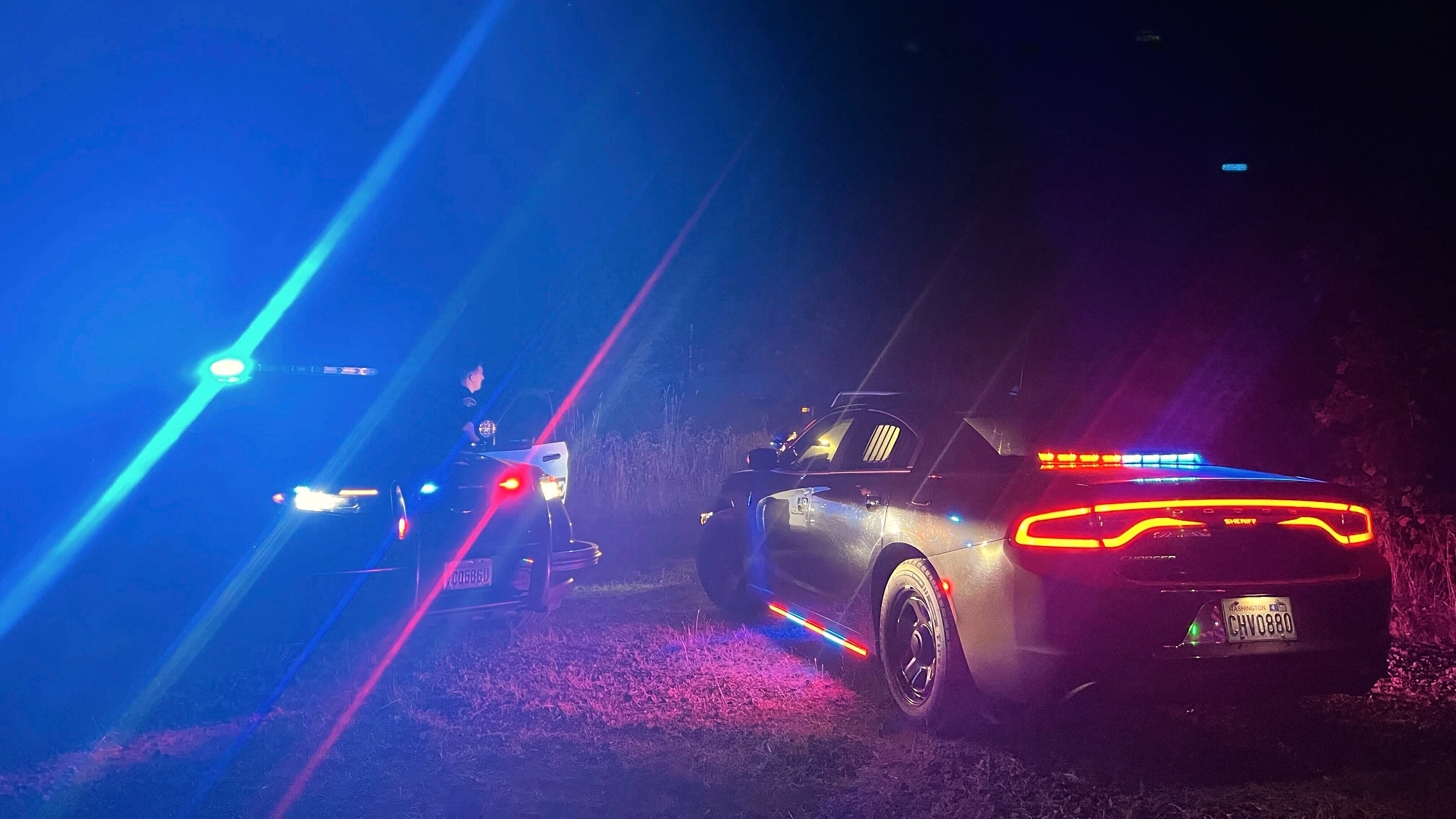 In this photo provided by the Thurston County Sheriff's Office, law enforcement personnel respond to a Wednesday evening, Sept. 17, 2025, helicopter crash near Joint Base Lewis-McChord in Washington state. (Thurston County Sheriff's Office via AP)