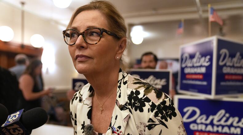 Sen. Darline Graham, R-S.C., leans over to hear a reporter's question following at a candidate event for hopefuls vying in a special Republican primary to replace her late brother Sen. Lindsey Graham, R-S.C., on November ballots, Saturday, Aug. 8, 2026, in Florence, S.C. (AP Photo/Meg Kinnard)