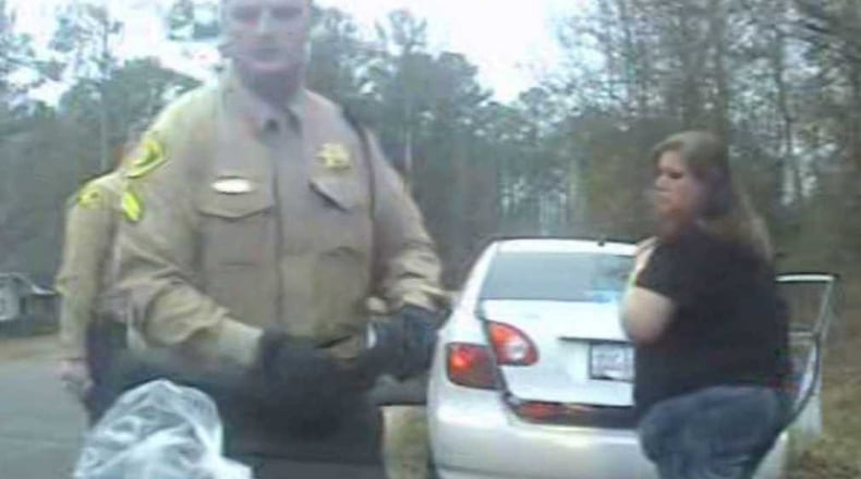 Dasha Fincher, right, looks on during a Dec. 31, 2016, traffic stop as Monroe County deputies search her car. She would spend 3 months in jail as a result of a drug analysis test that incorrectly signaled a bag of cotton canday was meth. (Provided dashcam photo)