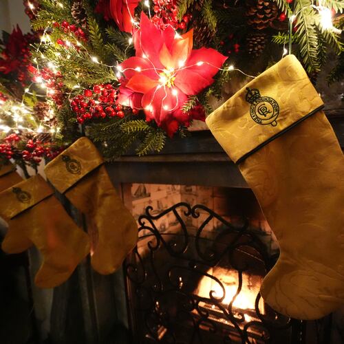 Christmas stockings created by members of the King's Foundation Sewing Bee group, which have been made using curtains repurposed from the Sandringham Estate in Norfolk, are hung from the fireplace in the Yellow drawing room at Dumfries House, which is part of The King's Foundation near Cumnock, Ayrshire, Scotland, Tuesday, Nov. 25, 2025. (Andrew Milligan/PA via AP)