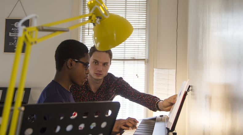 James Shealy (right), a music instructor, gives MaKhi Haynes, a teen student in Atlanta, a piano lesson during an afternoon session of the Kevin Baker Music Program. The program is part of the Friends of English Avenue nonprofit, and it works with kids in the area to teach them how to play different musical instruments. REANN HUBER / REANN.HUBER@AJC.COM