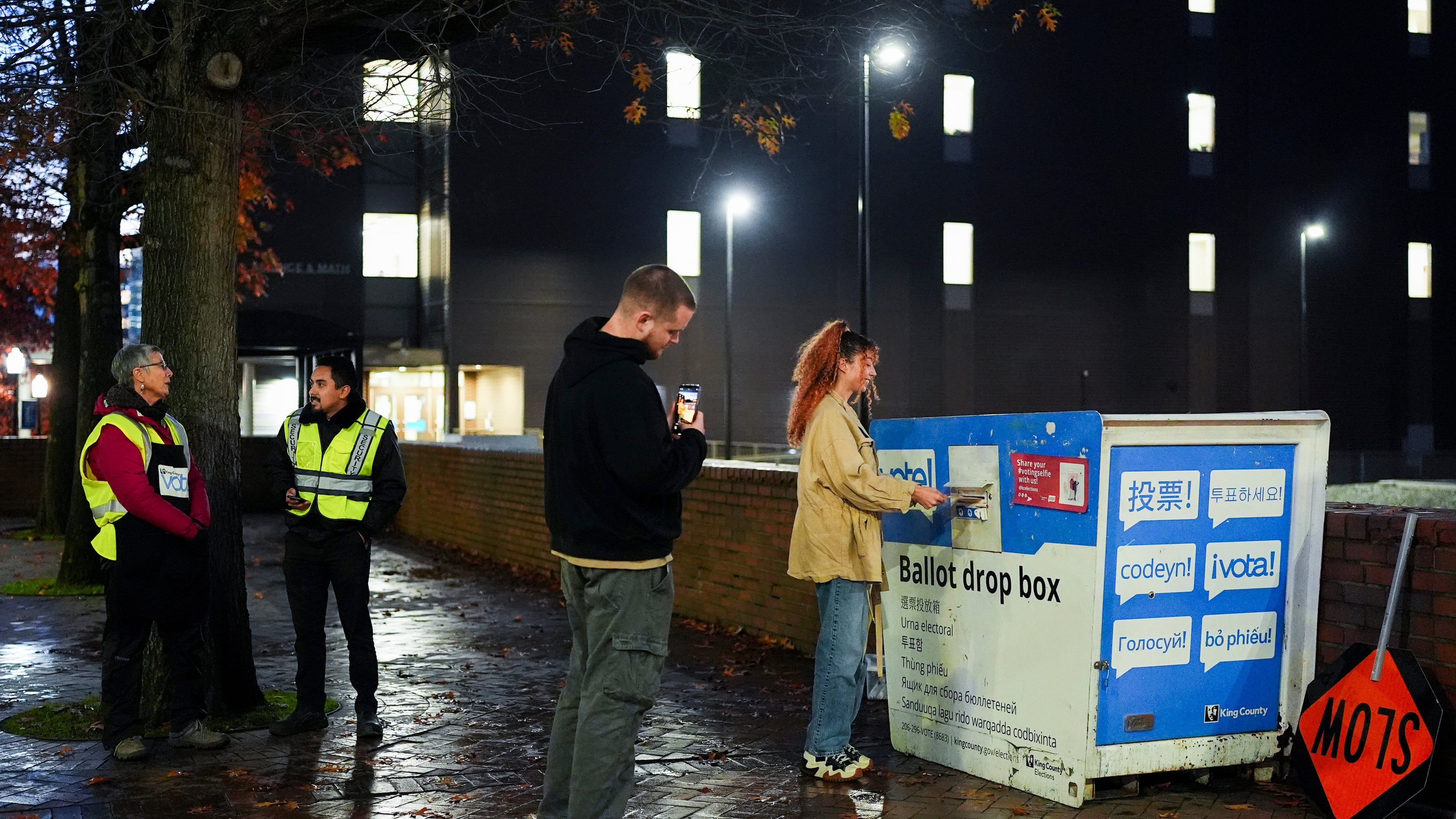 FILE - A voter poses for a photo as they place their ballot in a drop box on Election Day, Nov. 5, 2024, in Seattle. (AP Photo/Lindsey Wasson, File)
