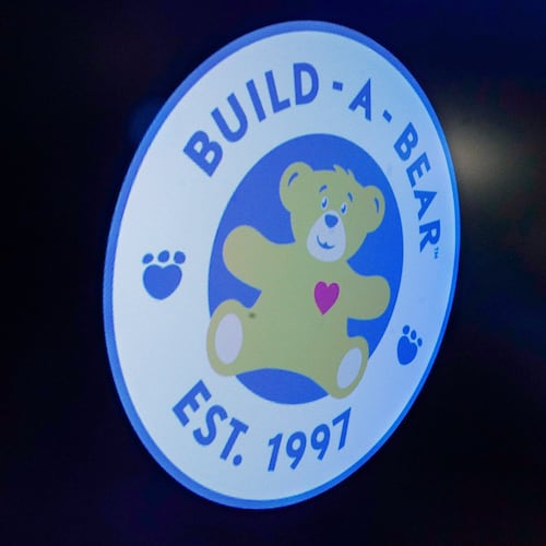 FILE - The logo for Build-A-Bear Workshop appears above a trading post on the floor of the New York Stock Exchange, Dec. 1, 2021. (AP Photo/Richard Drew, File)