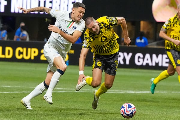 Monterrey's Lucas Ocampos, left, and Borussia Dortmund's Waldemar Anton compete for the ball during the Club World Cup round of 16 soccer match between Borussia Dortmund and CF Monterrey in Atlanta, Tuesday, July 1, 2025. (AP Photo/Mike Stewart)