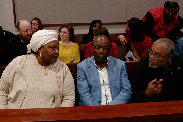 Patrick Lyoya's parents Dorcas, left, and Peter talk with translator Israel Siku, right, during a break in the sixth day of trial for former Grand Rapids Police officer Christopher Schurr, who is charged with second-degree murder in the fatal shooting of Patrick Lyoya, a Congolese immigrant, at the Kent County Courthouse in Grand Rapids, Mich., Monday, May 5, 2025. (Joel Bissell/MLive.com/Kalamazoo Gazette via AP)