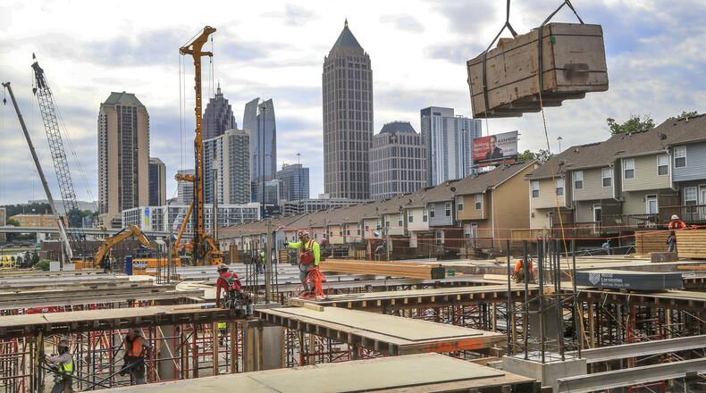 Workers were busy Thursday, April 18, 2019 at the construction site of Atlantic Yards, located along 17th Street at Atlantic Station in Atlanta. JOHN SPINK/JSPINK@AJC.COM