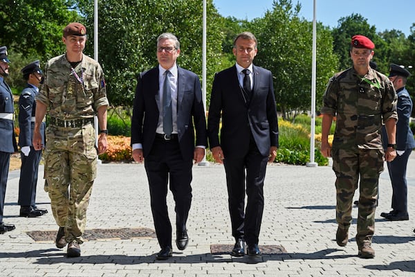 British Prime Minister Keir Starmer, centre left, and French President Emmanuel Macron, centre right, arrive for a joint military visit to the MARCOM centre, maritime command centre in Northwood, London, Thursday July 10, 2025. (Leon Neal/Pool Photo via AP)