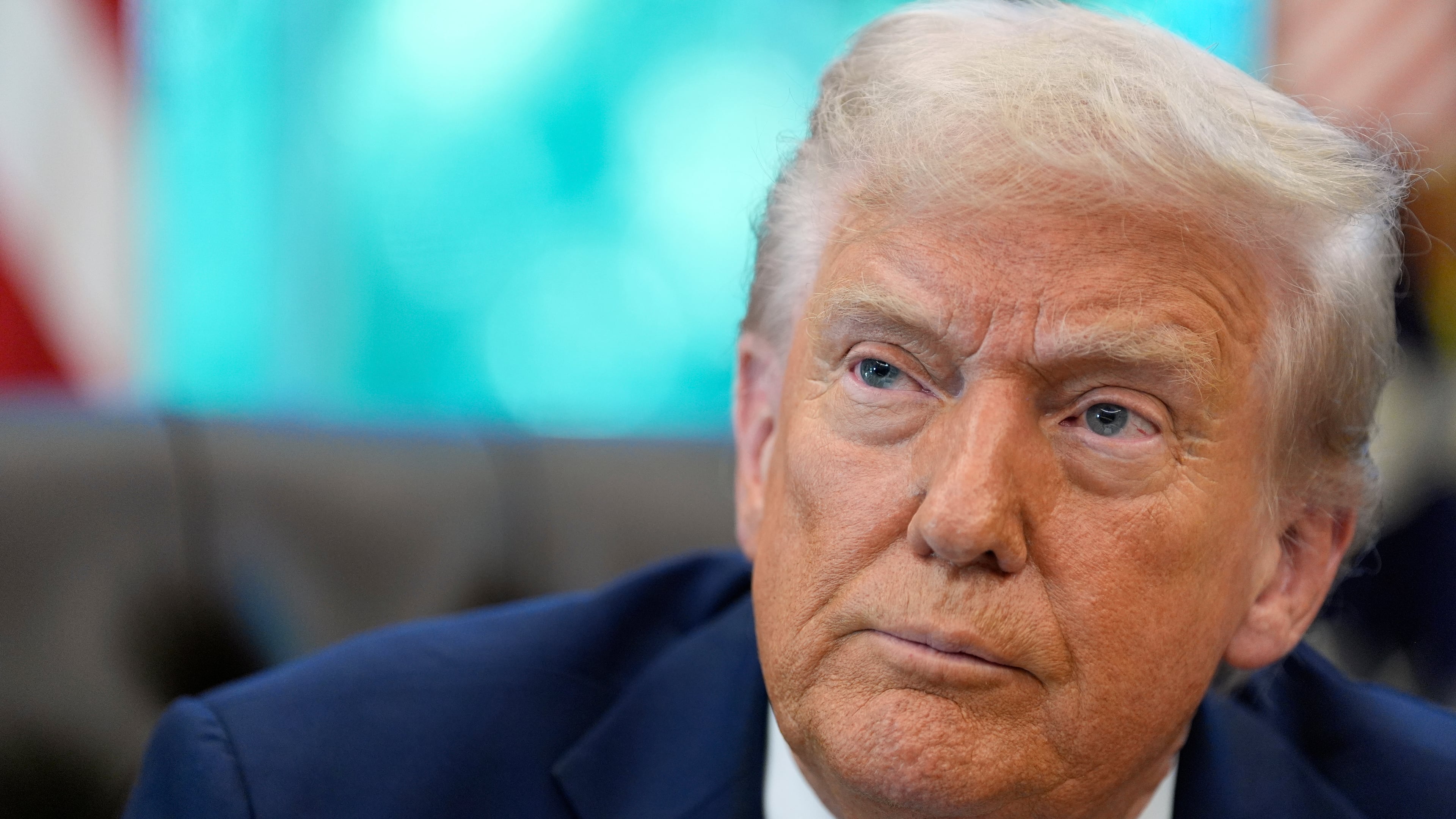 President Donald Trump listens to a reporter's question in the Oval Office of the White House, Friday, Sept. 19, 2025, in Washington. (AP Photo/Alex Brandon)