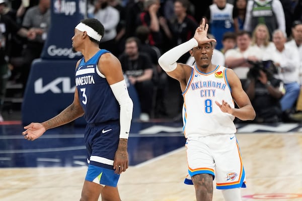 Oklahoma City Thunder forward Jalen Williams (8) gestures after making a 3-point basket next to Minnesota Timberwolves forward Jaden McDaniels (3) during the second half of Game 4 of the Western Conference finals of the NBA basketball playoffs Monday, May 26, 2025, in Minneapolis. (AP Photo/Abbie Parr)