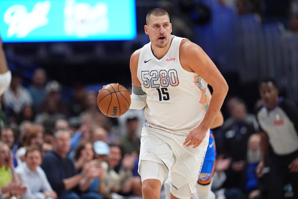Denver Nuggets center Nikola Jokic collects a loose ball in the first half of Game 6 in the Western Conference semifinals of the NBA basketball playoffs against the Oklahoma City Thunder Thursday, May 15, 2025, in Denver. (AP Photo/David Zalubowski)
