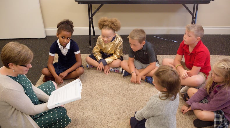 Teacher Katie Pearce reads to a first and second grade class at the Veritas Classical Schools. The hybrid program brings students together twice a week while promoting independent home study.