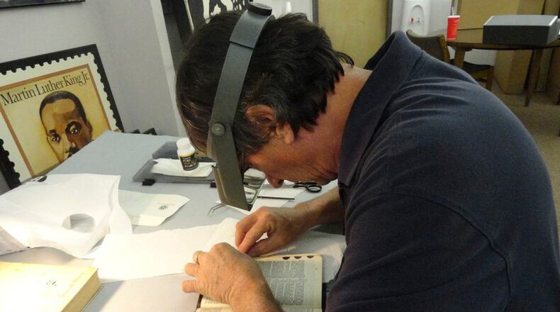 Gordon Ponsford, a conservator and owner of Ponsford Limited, repairs the Martin Luther King Bible that will be used by President Obama during his swearing in for his second term.