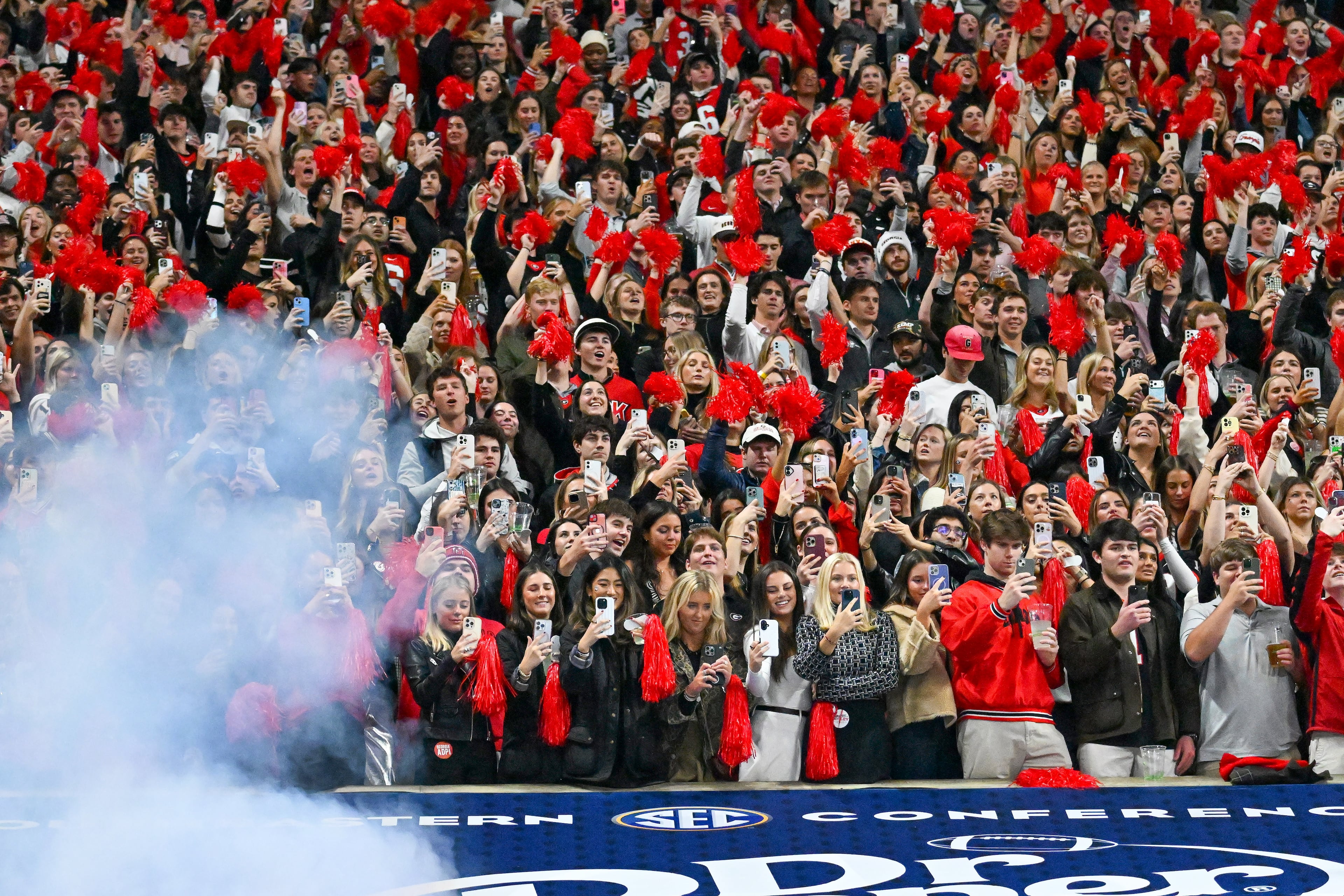 Georgia fans document the SEC Championship game with their smartphones at Mercedes-Benz Stadium, Saturday, Dec. 6, 2025, in Atlanta. (Hyosub Shin / AJC)
