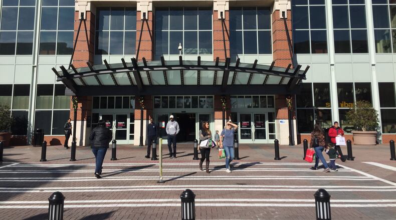 Shoppers enter and leave the Mall of Georgia on Saturday morning, Dec. 16, 2017, a holiday shopping day that so far was hardly more crowded than a regular Saturday.
