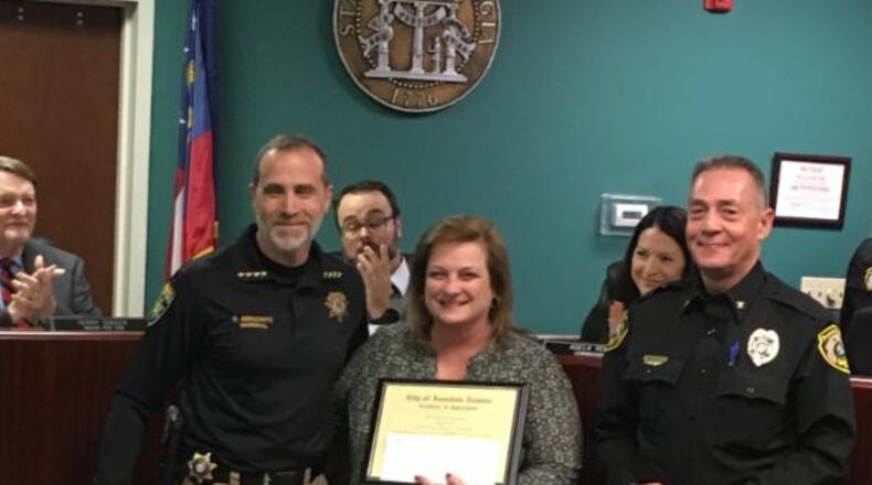 L-R: Marshal Richard Berkowitz, president of the DeKalb County Chiefs’ Association, Missy Owen, the executive director of the Davis Direction Foundation, and Avondale Estates Police Chief Lynn Thomas. The DDF recently donated 30 starter kits of NARCON, the opioid-overdose reversal drug, to the city’s police department. Courtesy of Avondale Estates
