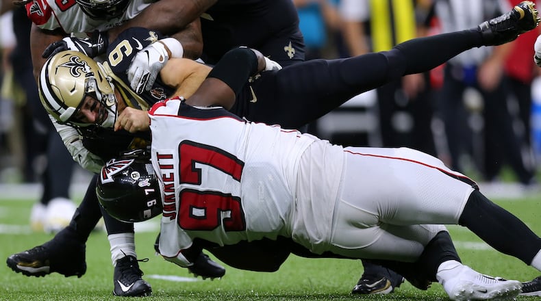 Drew Brees of the New Orleans Saints is sacked by Grady Jarrett of the Atlanta Falcons and Adrian Clayborn during the second half of a game at the Mercedes Benz Superdome on November 10, 2019 in New Orleans, Louisiana. (Photo by Jonathan Bachman/Getty Images)