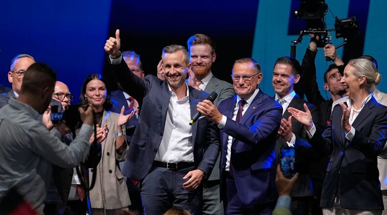 Top candidate Ulrich Siegmund shows thumbs up beside party leaders Tino Chrupalla and Alice Weidel, from left, at an election party of the "Alternative for Germany" (AfD) after the Saxony-Anhalt state elections in Magdeburg, eastern Germany, Sunday, Sept. 6, 2026. (AP Photo/Matthias Schrader)