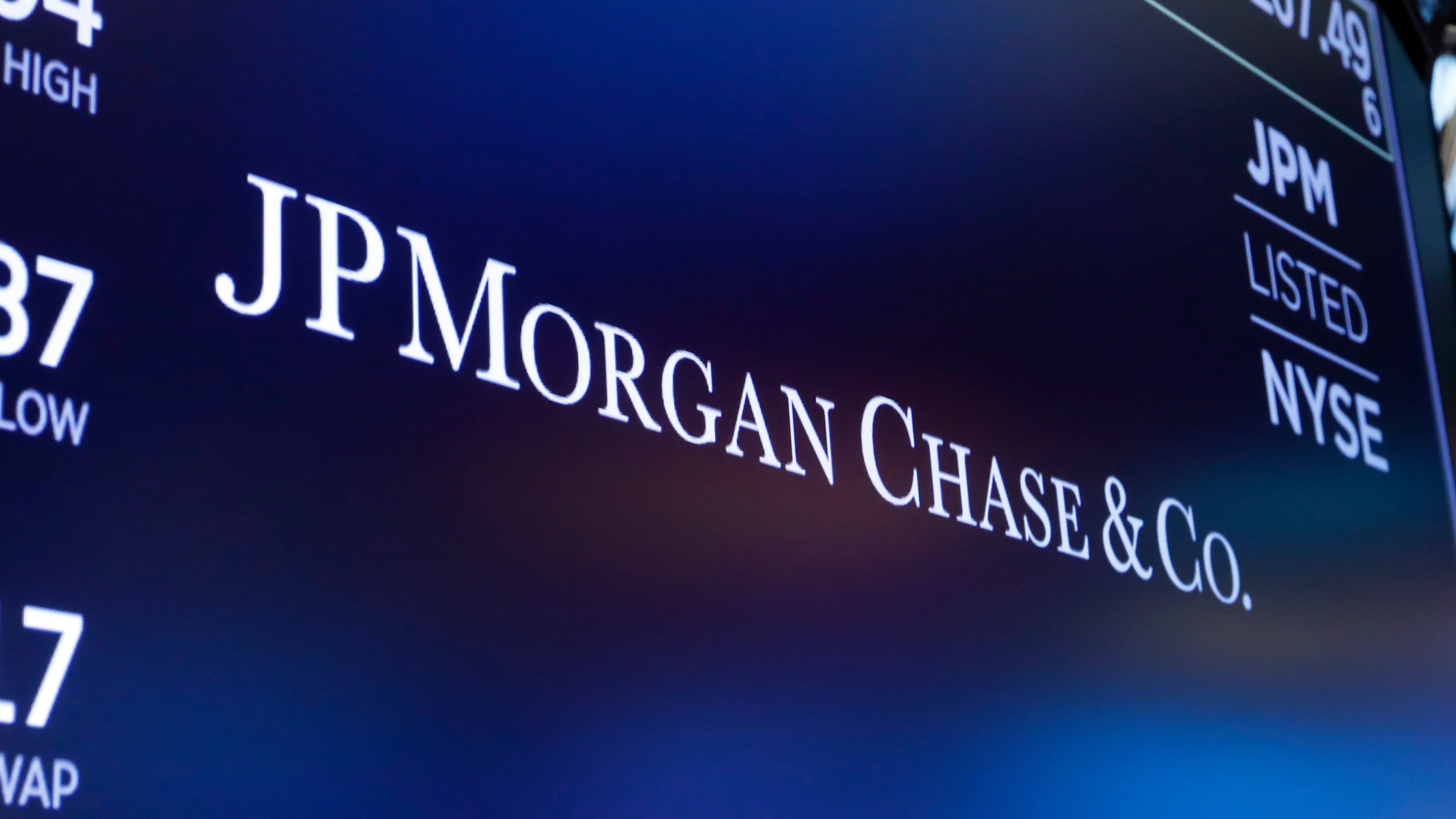 FILE - The logo for JPMorgan Chase & Co. appears above a trading post on the floor of the New York Stock Exchange in New York, Aug. 16, 2019. (AP Photo/Richard Drew, File)