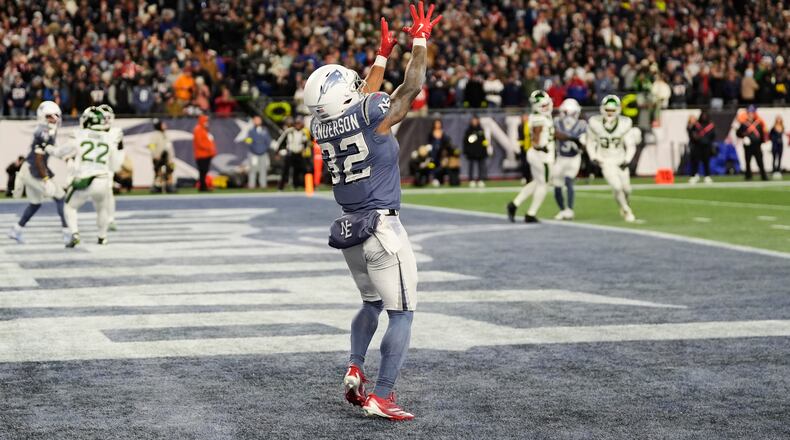 New England Patriots running back TreVeyon Henderson catches a touchdown pass during the second half of an NFL football game against the New York Jets, Thursday, Nov. 13, 2025, in Foxborough, Mass. (AP Photo/Charles Krupa)