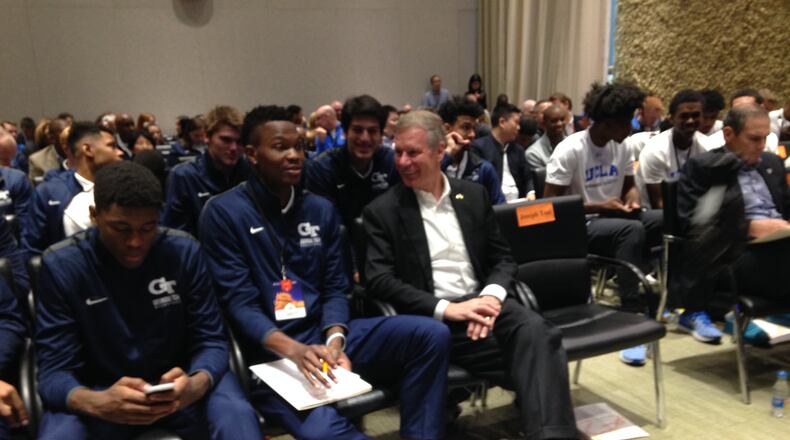 Georgia Tech forward Sylvester Ogbonda (left) and school president G.P. "Bud" Peterson share a word at the headquarters of Alibaba in Hangzhou, China, on Monday. (AJC photo by Ken Sugiura)