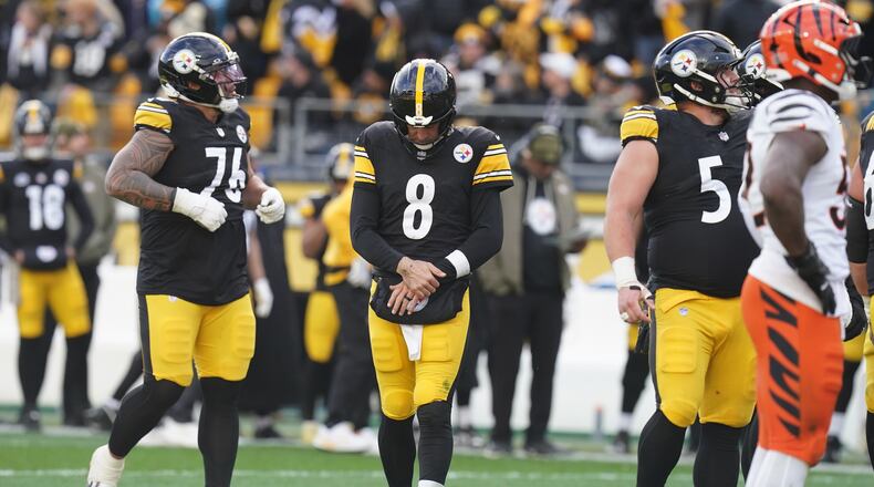 Pittsburgh Steelers quarterback Aaron Rodgers (8) holds his arm after a hit by the Cincinnati Bengals during the first half of an NFL football game Sunday, Nov. 16, 2025, in Pittsburgh. (AP Photo/Matt Freed)