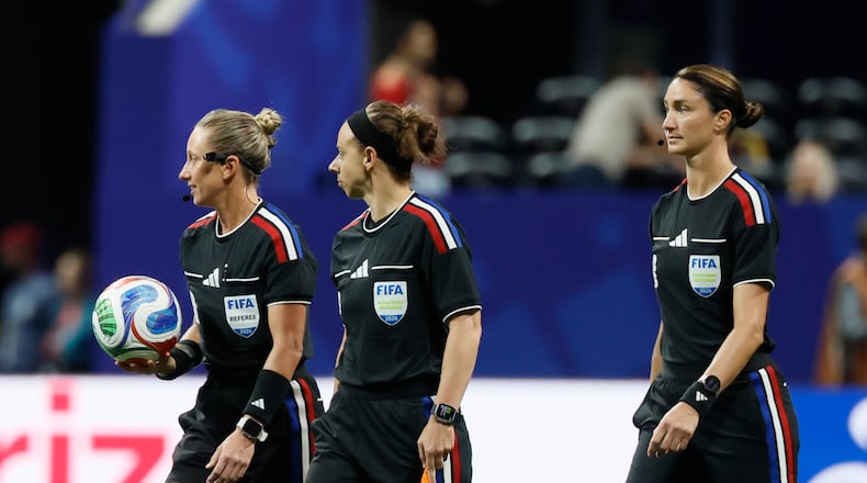 Head referee Tori Penso (left) is the first U.S. woman to be head ref at a World Cup match. She is joined by assistant referee Brooke Mayo (center) and Kathryn Nesbitt before the start of the Czechia vs. South Africa Group A FIFA World Cup match at Atlanta Stadium (Mercedes-Benz Stadium) on Thursday, June 18, 2026. (Miguel Martinez/AJC)