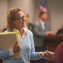 Former District Attorney Jackie Johnson smiles at a supporter who took her hand Monday after Senior Judge John R. Turner dismissed one of the two charges she faced.