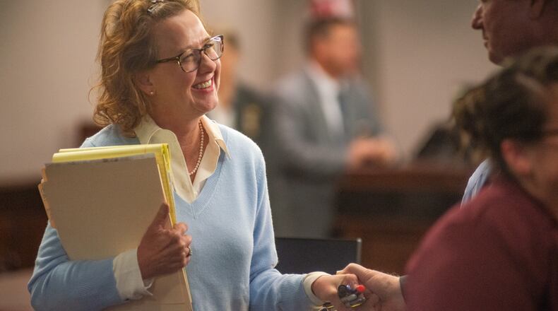 Former District Attorney Jackie Johnson smiles at a supporter who took her hand Monday after Senior Judge John R. Turner dismissed one of the two charges she faced.