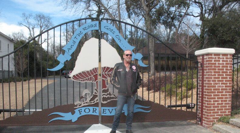 Gregg Allman was photographed near the gate to the Big House grounds in 2010. "The Road Goes On Forever" is a lyric from the Allman Brothers Band song "Midnight Rider." (Greg Potter / special)