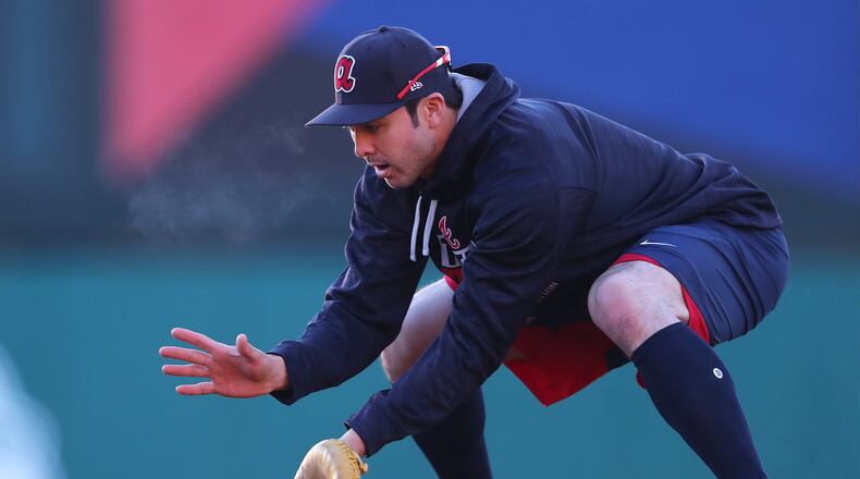Braves utility man Chase d’Arnaud, shown using an undersized glove during a spring-training fielding drill, could be an option as a backup first baseman. He got his first work at the position Saturday. (Curtis Compton/ccompton@ajc.com)