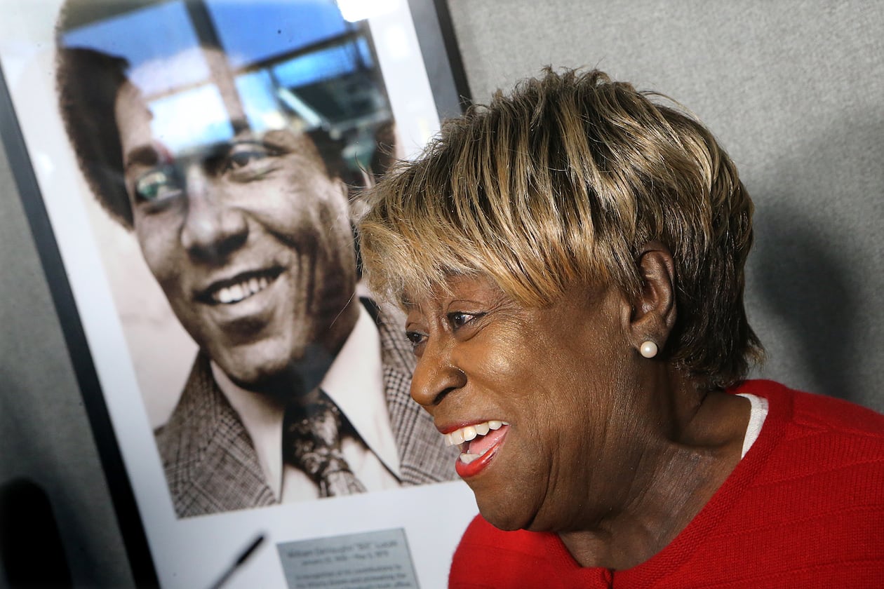 Rubye Lucas, widow of Bill Lucas, speaks next to his portrait during a ceremony naming the Braves' baseball operations conference room after Lucas, baseball's first Black general manager, in 2017. The dedication coincided with the 40th anniversary of Lucas' first season as Atlanta's vice president of player personnel. (Curtis Compton/AJC 2017)