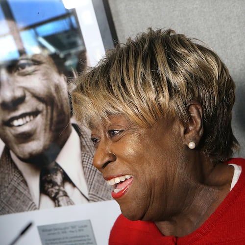 Rubye Lucas, widow of Bill Lucas, speaks next to his portrait during a ceremony naming the Braves' baseball operations conference room after Lucas, baseball's first Black general manager, in 2017. The dedication coincided with the 40th anniversary of Lucas' first season as Atlanta's vice president of player personnel. (Curtis Compton/AJC 2017)