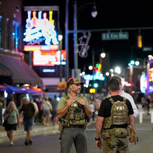 FILE - Federal law enforcement agents walk on Beale Street, Oct. 10, 2025, in Memphis, Tenn. (AP Photo/George Walker IV, File)