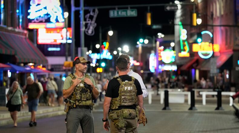 FILE - Federal law enforcement agents walk on Beale Street, Oct. 10, 2025, in Memphis, Tenn. (AP Photo/George Walker IV, File)