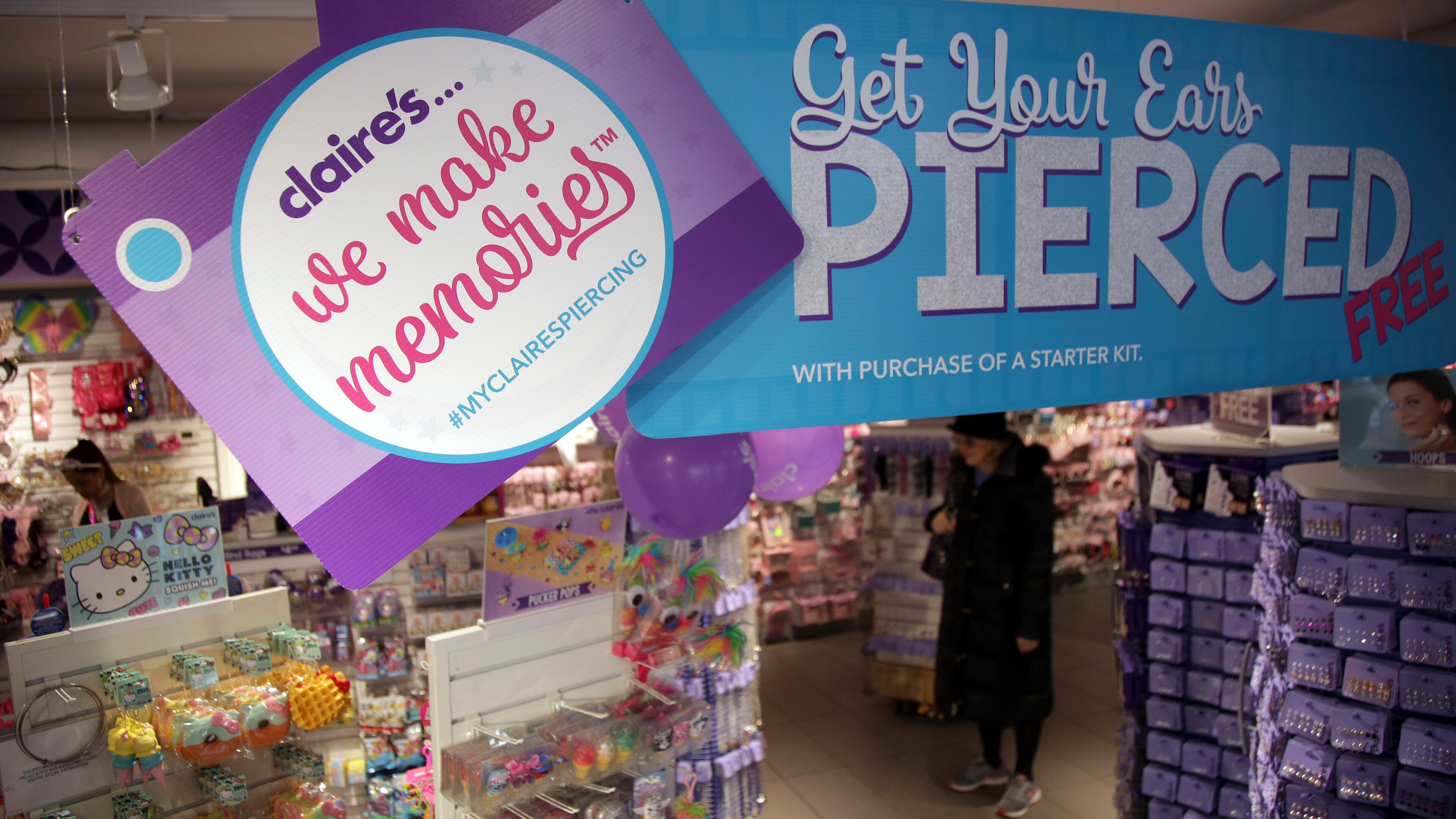 FILE - People shop at a Claire's in New York, Saturday, March 17, 2018. (AP Photo/Seth Wenig, File)