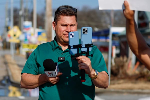 Mario Guevara, the metro Atlanta-based Spanish-language reporter, covers a protest against immigration enforcement on Buford Highway, in Georgia, Saturday, Feb. 1, 2025. (Miguel Martinez/Atlanta Journal-Constitution via AP)