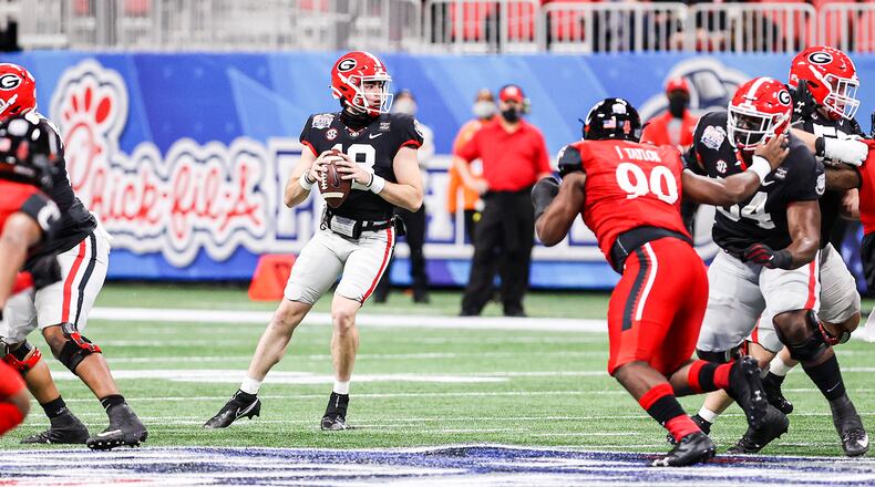 Georgia quarterback JT Daniels (18) prepares to unleash a pass against Cincinnati in the Chick-fil-A Peach Bowl at the Mercedes-Benz Stadium in Atlanta on Friday, Jan. 1, 2020. (Photo by Tony Walsh/UGA Athletics)
