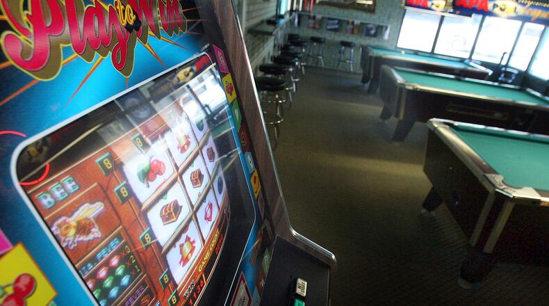 070305 -- Lilburn, GA -- (all cq) In the back room of the restaurant, A Sports Fan, a video game and billiard tables are shown Monday afternoon in Lilburn, Ga., March 5, 2007. Owner Richard Tao and his restaurant are under pressure from the City of Lilburn to remove entertainment such as billiard tables, video games, poker games, and karaoke night that are popular at the restaurant. (JASON GETZ / AJC Staff)