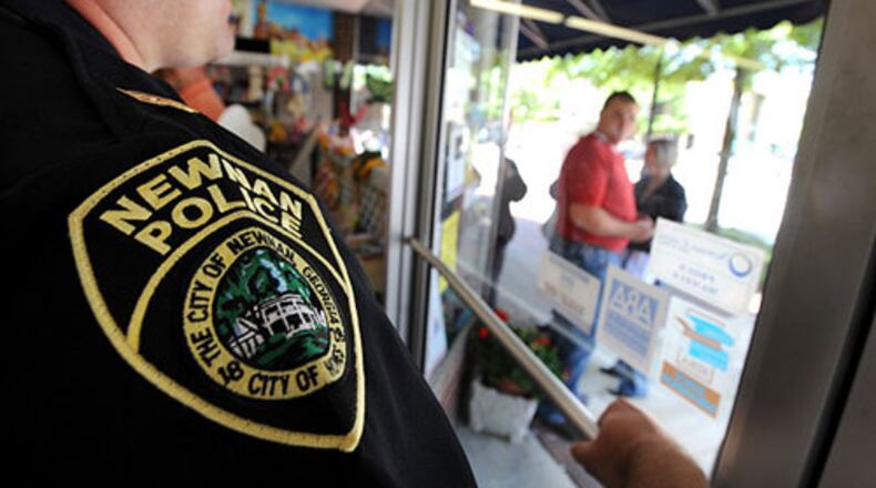 A Newnan officer was fired and criminally charged Friday after crashing his car while driving to work, police said.