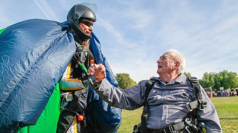 Stanley Rohrer (right), a double amputee who turned 90 on Jan. 7, shakes hands with tandem instructor Romulo Rangel (left) after their jump at Skydive Elsinore on Jan. 3, 2020 in Lake Elsinore, Calif. (Eduardo Contreras/San Diego Union-Tribune/TNS)