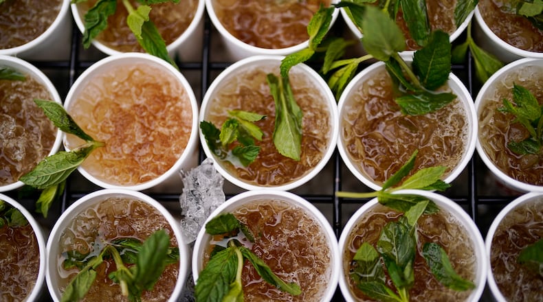 Cups of Mint Julep are prepared for a vender before the 149th running of the Kentucky Derby horse race at Churchill Downs Saturday, May 6, 2023, in Louisville, Ky. (AP Photo/Brynn Anderson)