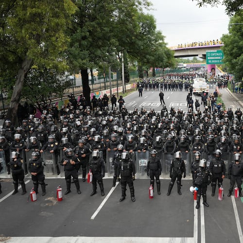 Police block an avenue to prevent protesting teachers from marching to the stadium that will host the opening match of the FIFA World Cup in Mexico City, Tuesday, June 9, 2026. (AP Photo/Eduardo Verdugo)