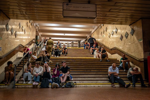 People rest in a metro station, being used as a bomb shelter, during a Russian drones attack in Kyiv, Ukraine, early Friday, June 6, 2025. (AP Photo/Dan Bashakov)