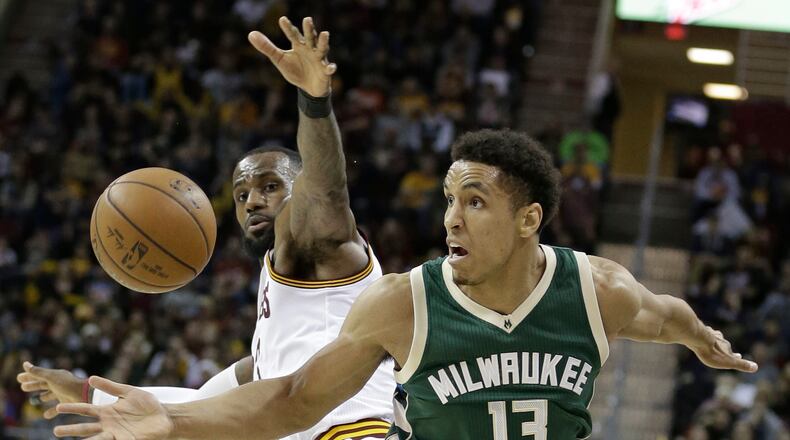 Cleveland Cavaliers' LeBron James, left, and Milwaukee Bucks' Malcolm Brogdon watch the ball during the second half of an NBA basketball game, Wednesday, Dec. 21, 2016, in Cleveland. The Cavaliers won 113-102.